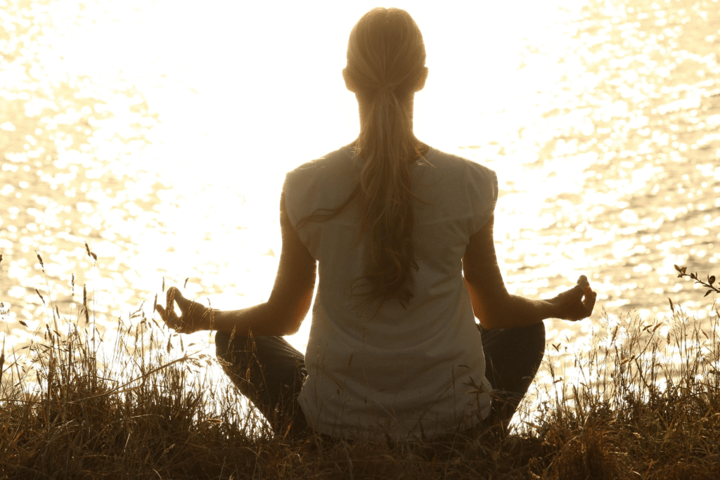 Woman meditating outdoors for mental clarity and wellness