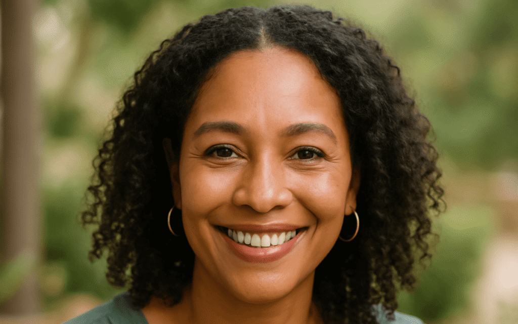 Victoria David – midlife wellness researcher for women over 40, smiling confidently in a natural outdoor setting